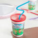 A white plastic kids cup with a straw and a lid.