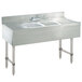 A stainless steel Advance Tabco underbar sink with two bowls and two drains.