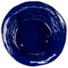 A cobalt blue bowl with a blue rim and white interior.