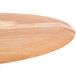 An American Metalcraft oval olive wood serving board on a table.