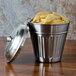 A close-up of an American Metalcraft stainless steel mini trash can lid full of fries.