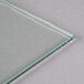 An Avantco glass panel with a green edge on a white surface.