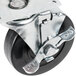 A black metal 4" swivel plate caster with brake.