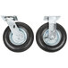 Two black Rubbermaid pneumatic casters with silver metal wheels.