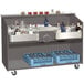 An Advance Tabco portable bar with a stainless steel counter holding bottles and containers.