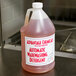 A bottle of Advantage Chemicals concentrated liquid dish washing machine detergent on a counter.