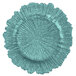 A close up of a teal glass charger plate with a spiral design.