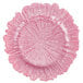 A pink Charge It by Jay glass charger plate with a textured edge and flower pattern.