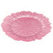 A pink Charge It by Jay glass charger plate with a textured flower pattern.