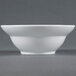 An American Metalcraft Prestige white stoneware bowl on a gray surface with a small rim.