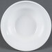An American Metalcraft white stoneware bowl with a rim on a gray background.