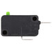 A close-up of a black rectangular Solwave interlock micro switch with a green button.
