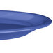 A close-up of a Carlisle Ocean Blue melamine plate with a rim.