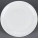 A CAC Majesty European bone china coupe plate with a white rim on a gray surface.