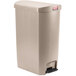 A beige Rubbermaid Slim Jim step-on trash can with lid.