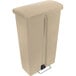 A tan plastic Rubbermaid Slim Jim front step-on trash can with a metal handle.