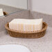 A white basket of Lavex Linen-Feel Elite paper towels on a counter.