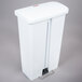 A white plastic Rubbermaid Slim Jim trash can with a front step-on lid.