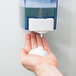 A person's hand with Noble Chemical foam from a soap dispenser.