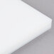 A white plastic filler plate for a VacMaster packaging machine.