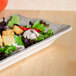 A salad on a rectangular Thunder Group Jazz melamine tray with a scalloped crackle-finished border.