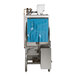 A commercial conveyor high temperature dishwasher with a stainless steel body and blue plastic curtain, designed for left to right operation.