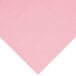 A close-up of a pink paper with a white background.