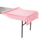 A table with a Classic Pink Creative Converting plastic table cover.