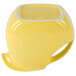 A close up of a yellow Fiesta disc pitcher with a handle containing a yellow liquid.