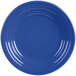 A close-up of a Fiesta® Lapis luncheon plate with a blue rim and circular pattern.