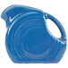 A blue Fiesta creamer pitcher with a handle.