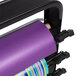 A purple roll of paper on a black Bulman countertop paper cutter rack.