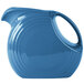 A blue Fiesta Disc China Pitcher with a handle.
