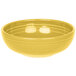 A yellow Fiesta Bistro bowl with ripples on a white surface.