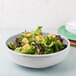 A white Fiesta china bistro bowl filled with salad topped with croutons.