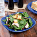 A Fiesta lapis square luncheon plate with salad, meat, and croutons on it.