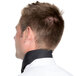 The back of a man's neck with a black chef neckerchief.