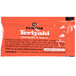 A Kikkoman Teriyaki Marinade & Sauce packet with black and orange packaging.