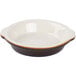 A white and brown Tuxton round au gratin dish with a handle.