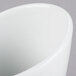 A close-up of a TuxTrendz Linx bright white tall slanted side dish.