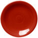 A close-up of a Fiesta® Scarlet round bread and butter plate with a circular pattern in the middle.