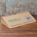 A GreenBox cardboard pizza box with a logo.