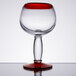A Libbey Aruba cocktail glass with a red rim and base.