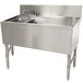 A stainless steel Advance Tabco 2 compartment underbar sink with a drain.