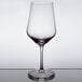 A close-up of a Stolzle all-purpose wine glass with a white rim.