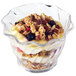 A Cambro clear plastic swirl dessert dish filled with yogurt, granola, and berries.
