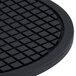 An American Metalcraft black round silicone trivet with a grid pattern.