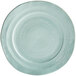 A mint green melamine plate with a circular design.