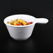 A white Elite Global Solutions Pebble Creek handled bowl with fruit inside.
