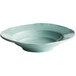 A close-up of a mint green Elite Global Solutions Della Terra bowl with a blue rim.